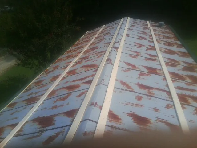 Rusted metal roof panels with new wood purlins before replacement — Storm Damage Roof Repair in Wind Gap by Roofing Brothers